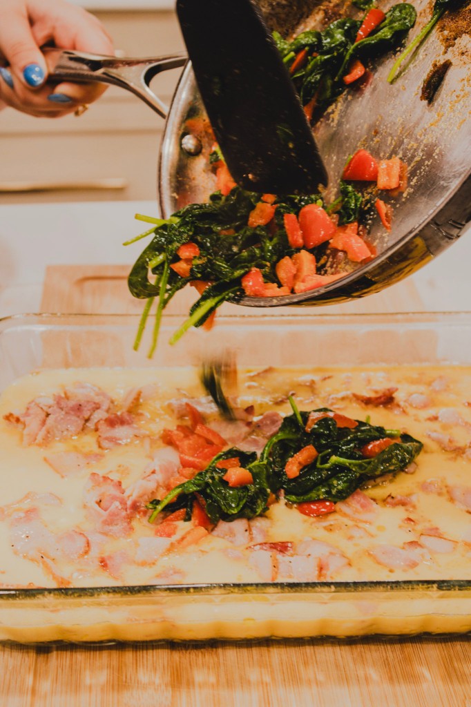 Spinach and peppers poured into a baking dish