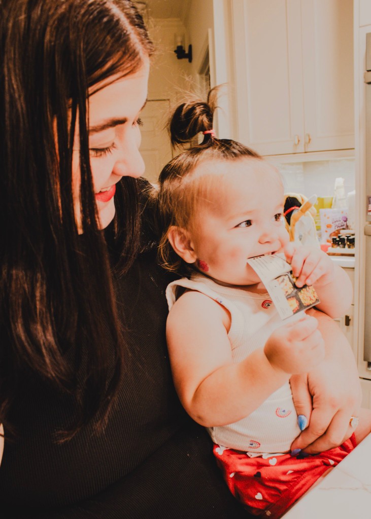 A warm candid moment of Kyla and her child in the kitchen