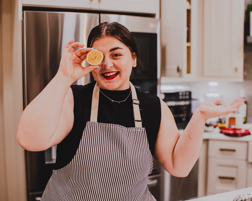 Kyla smiling in her apron in the Hope & Harvest kitchen