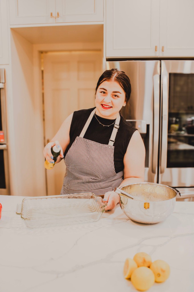 Kyla prepping a baking dish in her kitchen