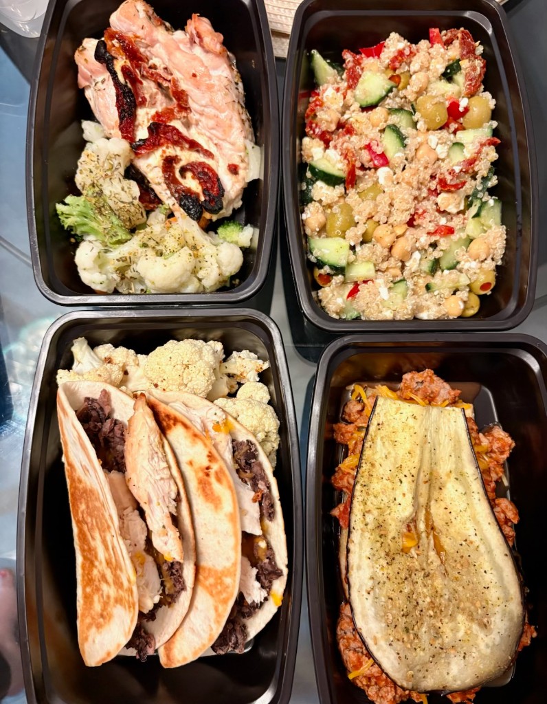 Four meal prep containers ready for the week